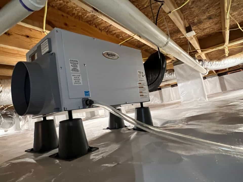 HydroHelp911 Crawl Space & Foundation Repair installing a dehumidifier and vapor barrier in an encapsulated crawl space.