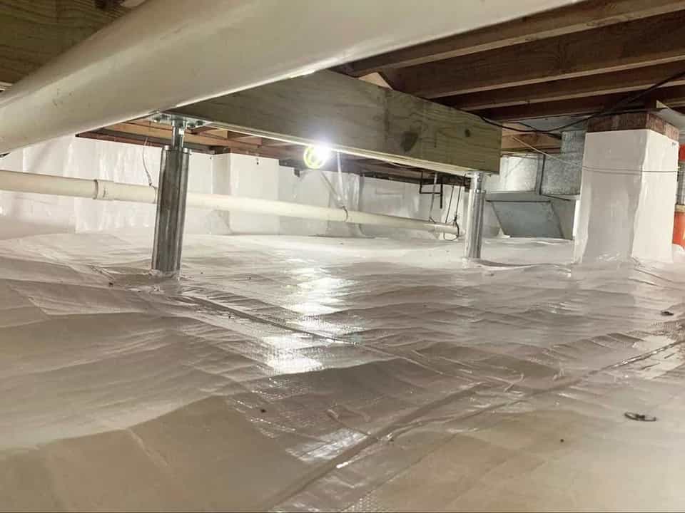 HydroHelp911 Crawl Space & Foundation Repair installing adjustable smart jacks and a vapor barrier in a crawl space.
