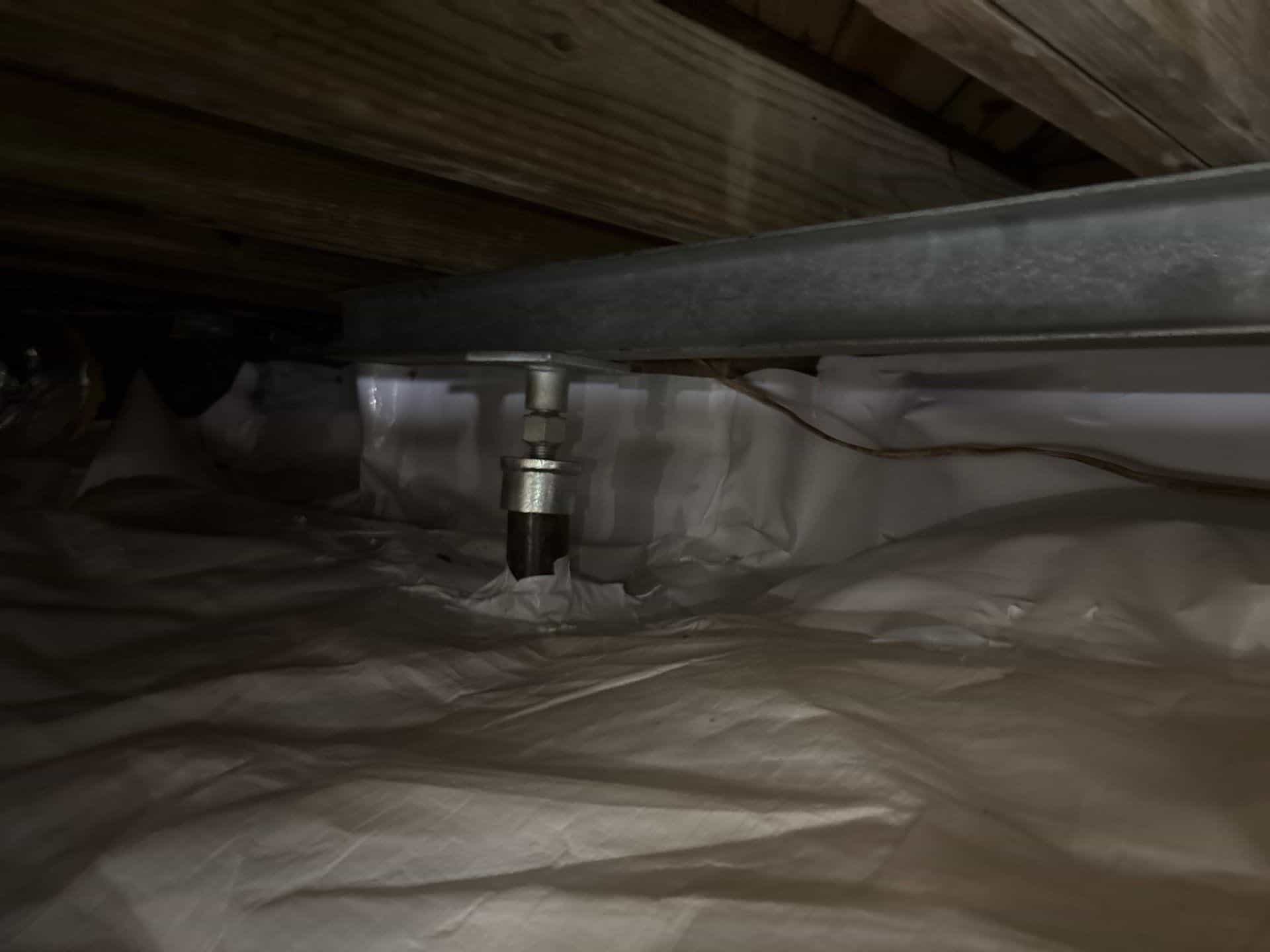 HydroHelp911 Crawl Space & Foundation Repair installing adjustable steel jacks and support beams in a crawl space.