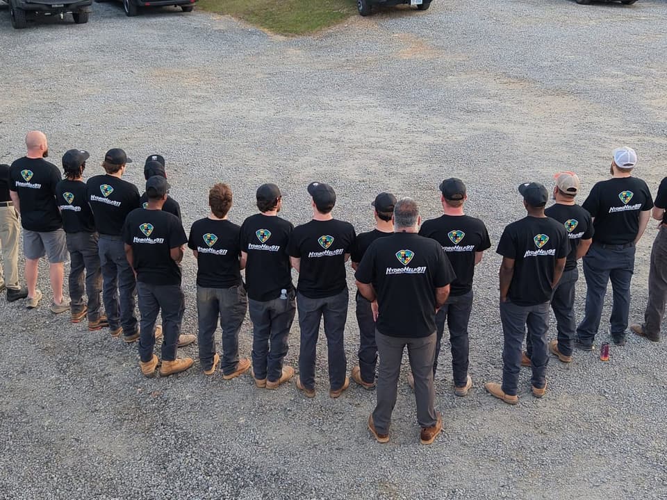 HydroHelp911 team members lined up in matching company shirts