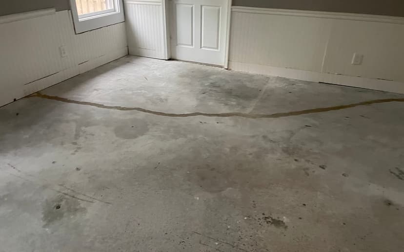 A sealed crack running across an interior concrete floor