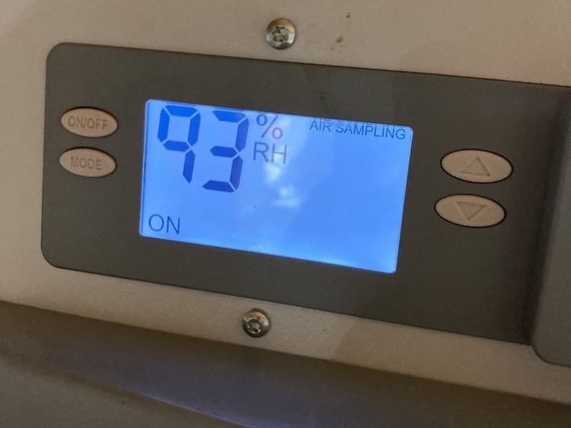 A dehumidifier display reading 93 percent relative humidity