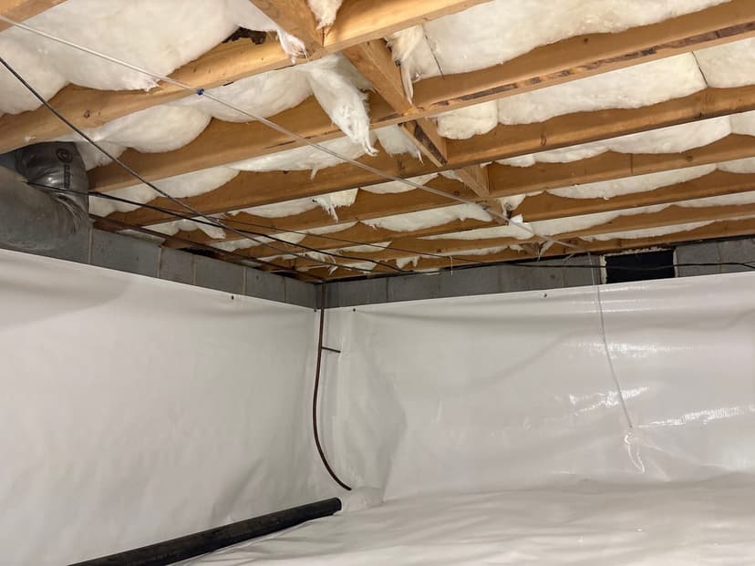 Insulation between the floor joists above a crawl space lined with a white liner