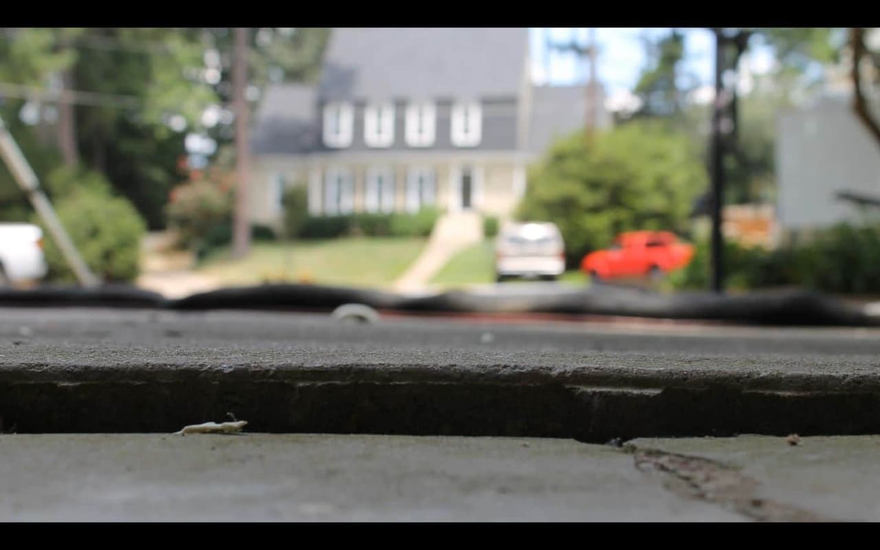 HydroHelp911 Crawl Space & Foundation Repair inspecting uneven concrete sidewalk slabs and a trip hazard.