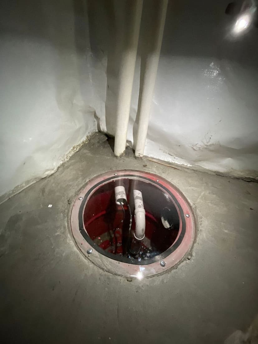 HydroHelp911 Crawl Space & Foundation Repair installing a sump pump with a sealed sump basin lid and discharge pipes.