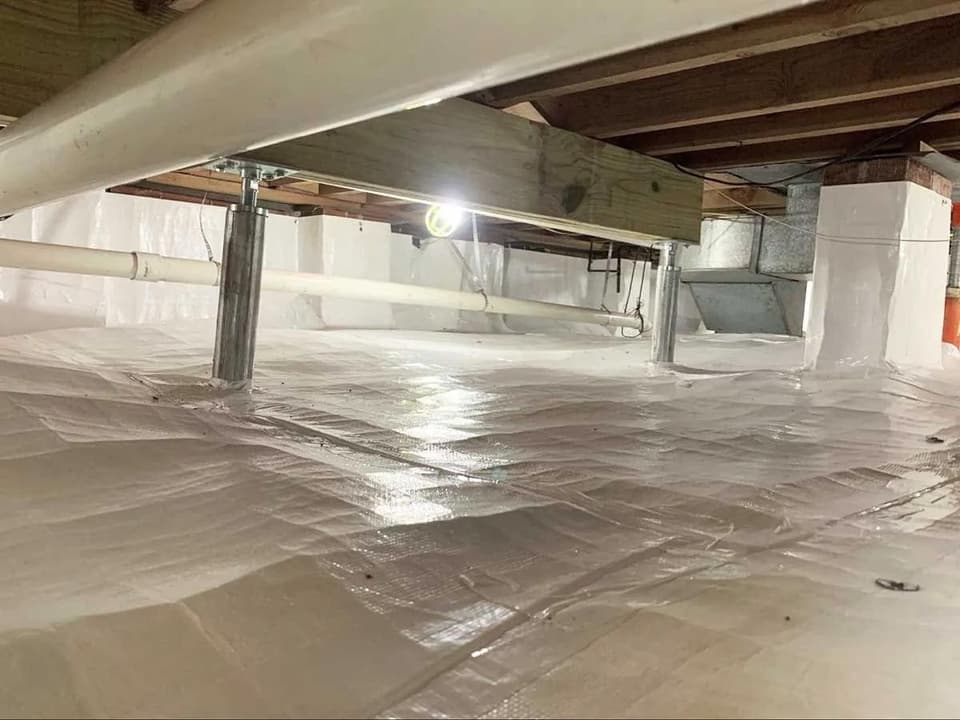 HydroHelp911 Crawl Space & Foundation Repair installing adjustable smart jacks and a vapor barrier in a crawl space.