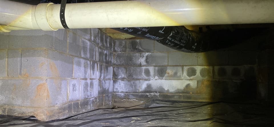 HydroHelp911 Crawl Space & Foundation Repair inspecting efflorescence and moisture on crawl space block walls.