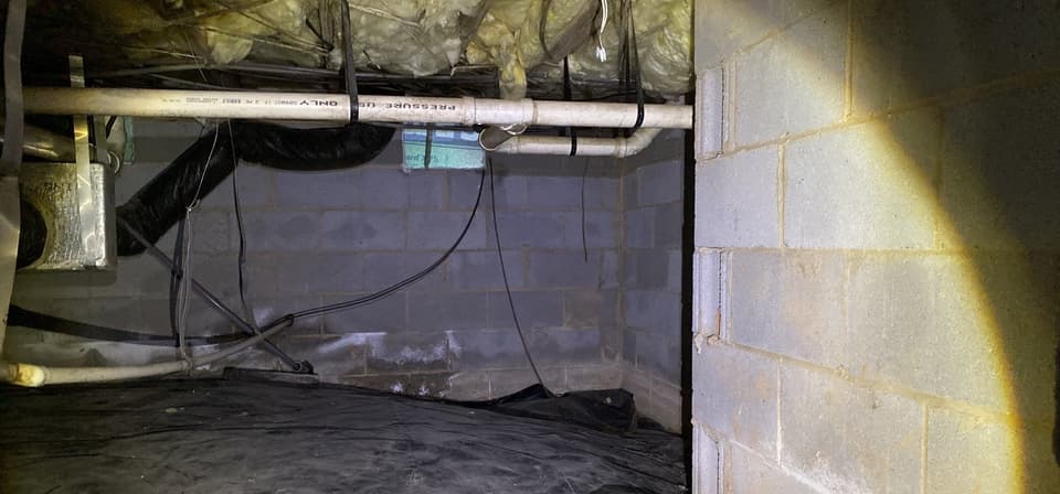 HydroHelp911 Crawl Space & Foundation Repair inspecting efflorescence and deteriorating insulation in a crawl space.