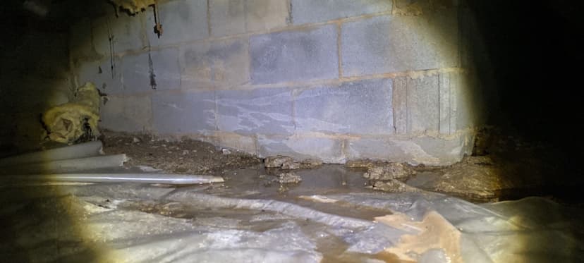 HydroHelp911 Crawl Space & Foundation Repair inspecting pooled water and damp conditions in a crawl space.