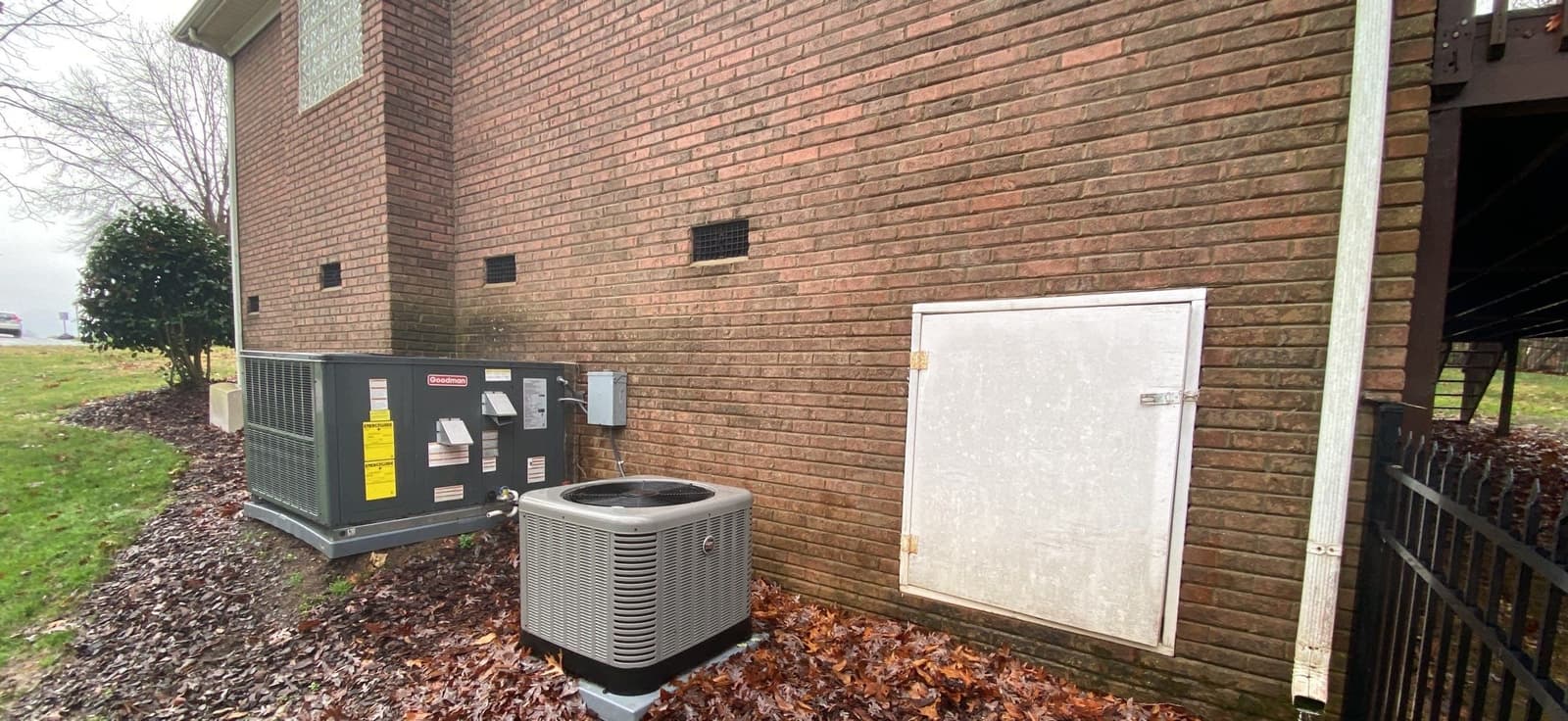HydroHelp911 Crawl Space & Foundation Repair inspecting an exterior brick foundation with improper drainage