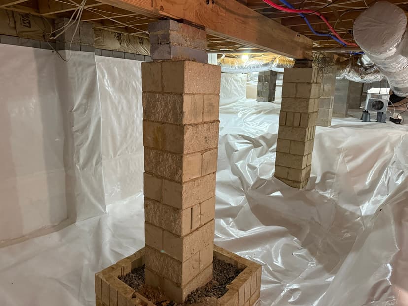 HydroHelp911 Crawl Space & Foundation Repair completing a crawl space encapsulation with a vapor barrier and block piers.