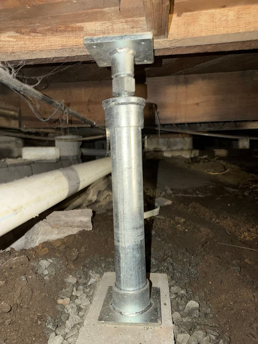 HydroHelp911 Crawl Space & Foundation Repair installing an adjustable steel jack to support sagging floor joists