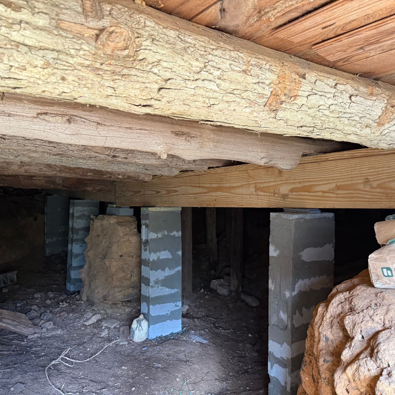 HydroHelp911 Crawl Space & Foundation Repair installing concrete piers for pier and beam repair in a crawl space.
