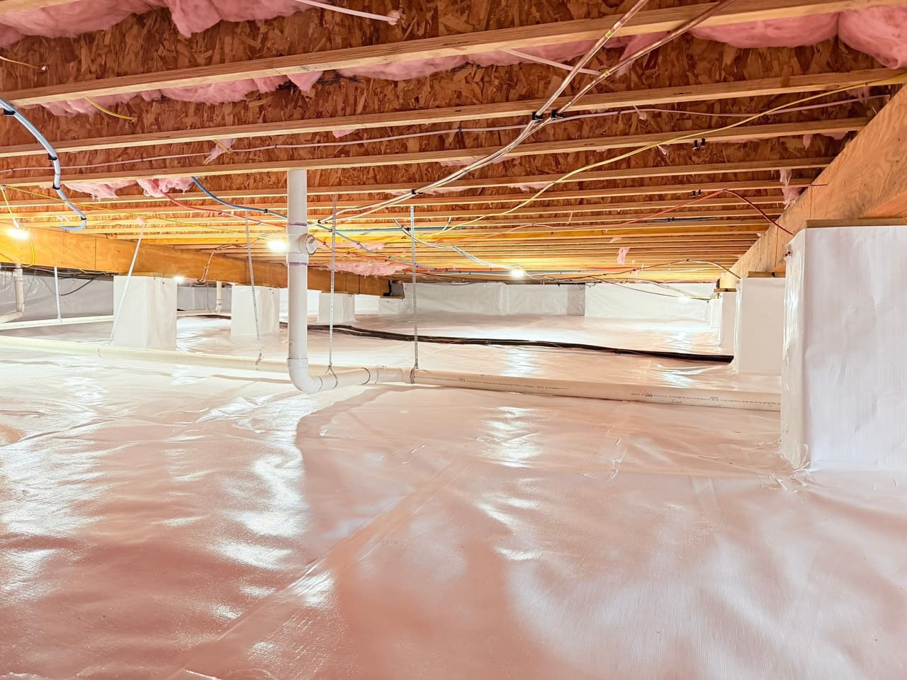 HydroHelp911 Crawl Space & Foundation Repair completed crawl space encapsulation with a bright white vapor barrier.