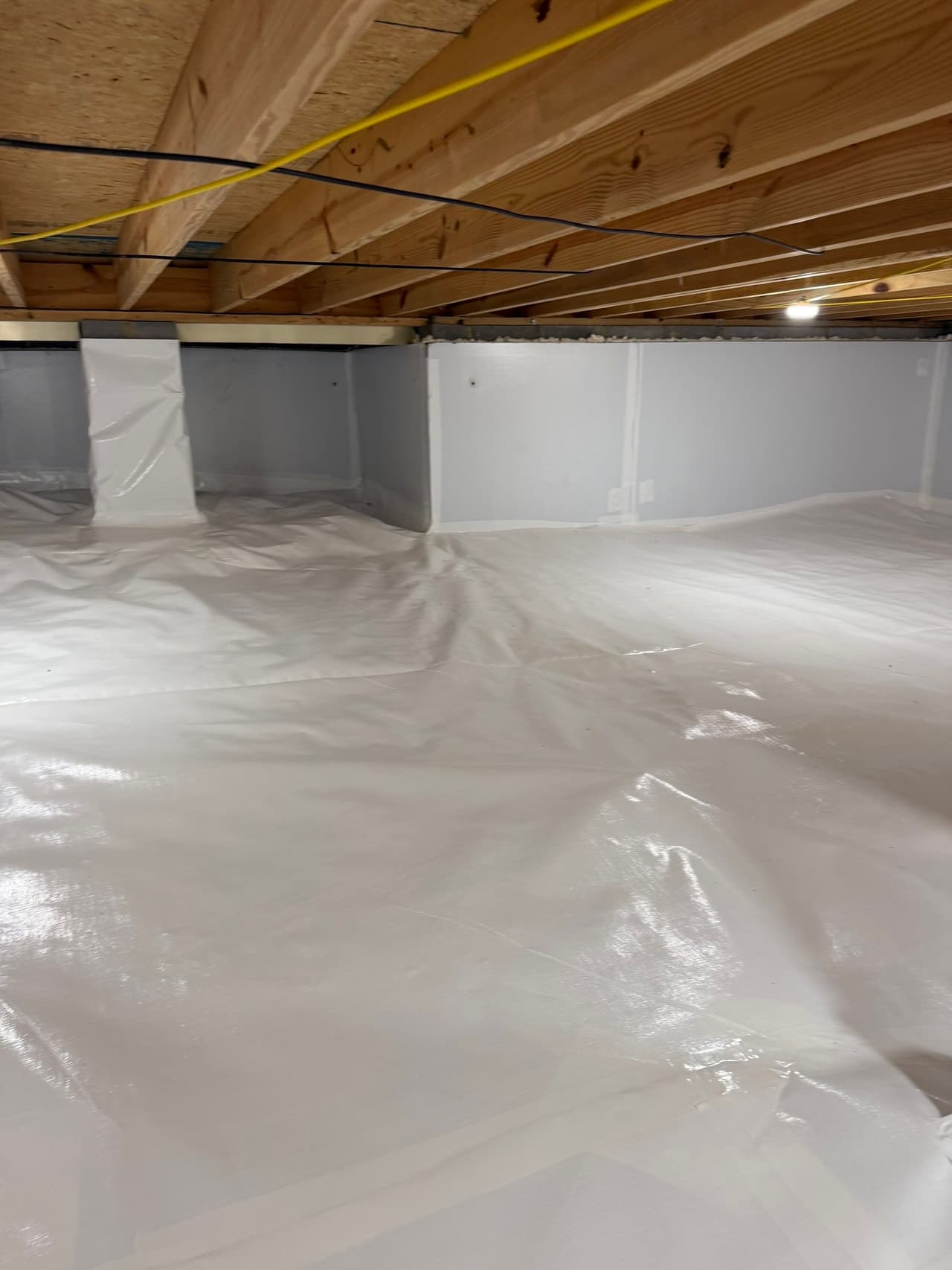 HydroHelp911 Crawl Space & Foundation Repair completed crawl space encapsulation with vapor barrier and sealed walls.