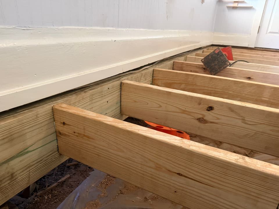 HydroHelp911 Crawl Space & Foundation Repair installing new floor joists in a crawl space to fix sagging floors.