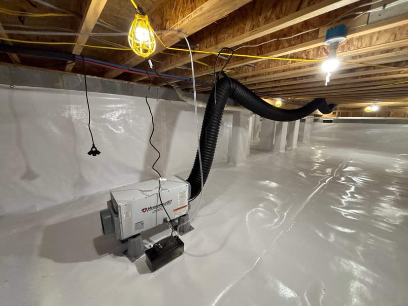 HydroHelp911 Crawl Space & Foundation Repair installing a dehumidifier in a newly encapsulated crawl space.