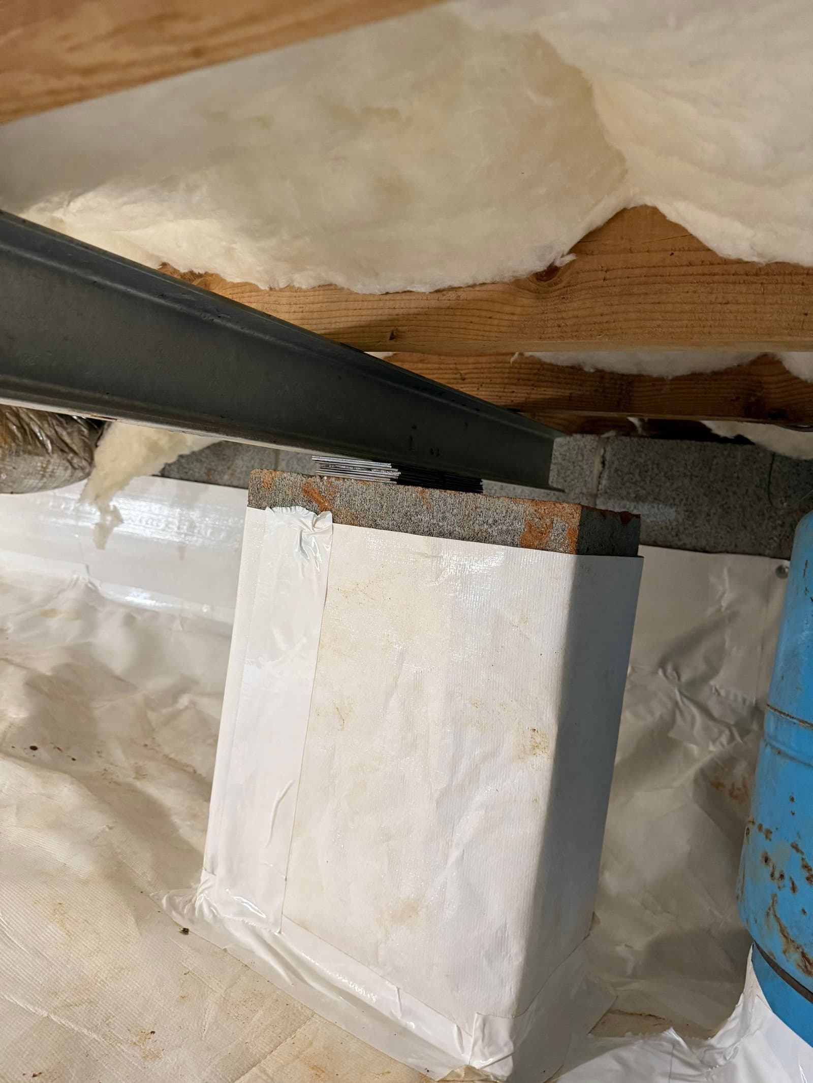 HydroHelp911 Crawl Space & Foundation Repair installing insulation and a vapor barrier in a crawl space with exposed joists.