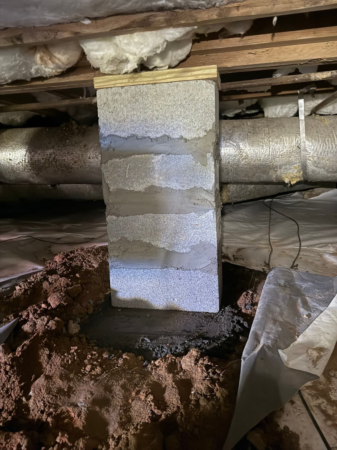 HydroHelp911 Crawl Space & Foundation Repair installing a new block pier for structural support.