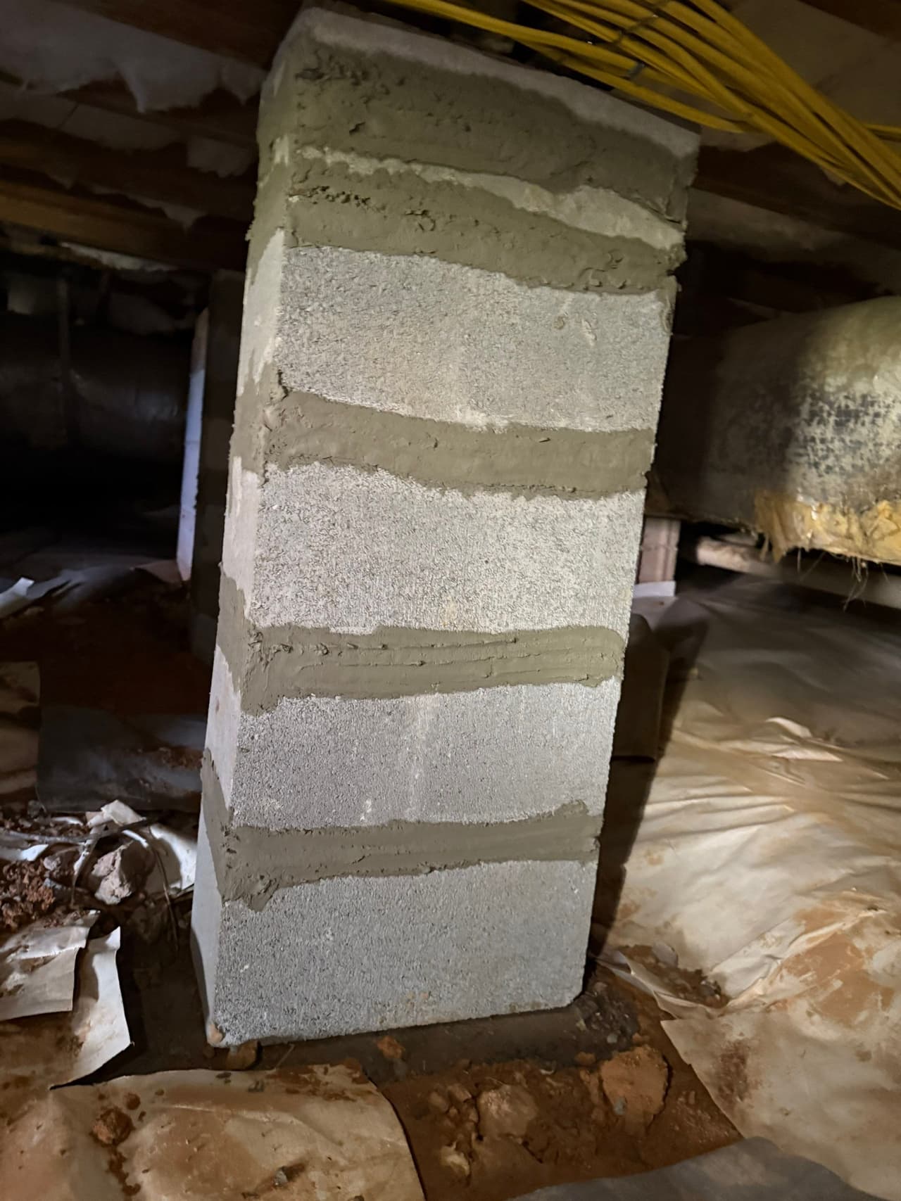 HydroHelp911 Crawl Space & Foundation Repair installing a new concrete block pier for crawl space structural repair.