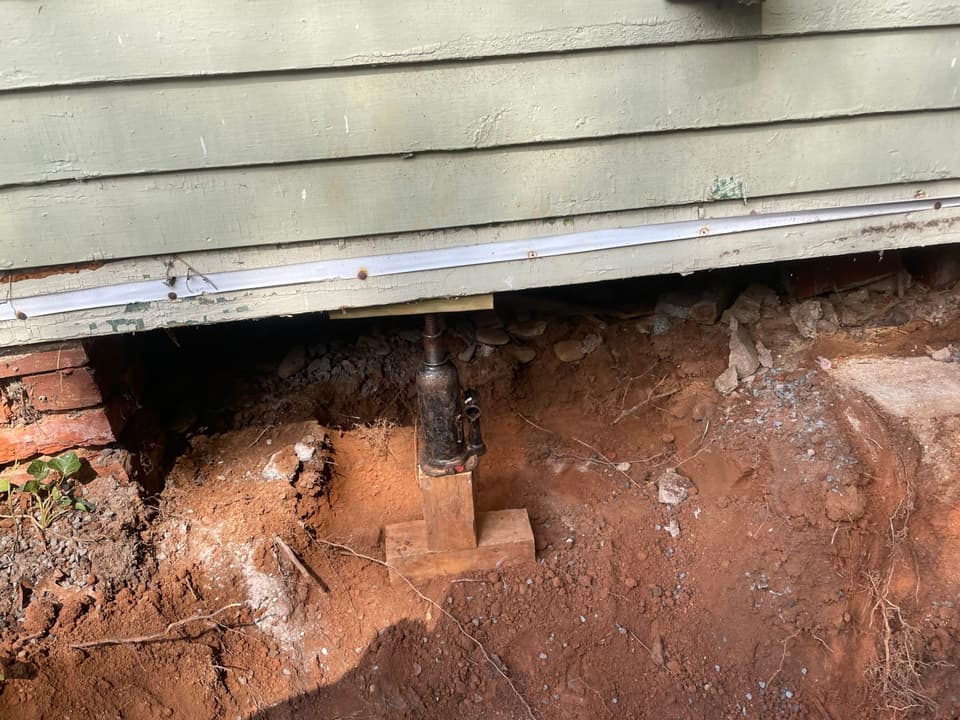 HydroHelp911 Crawl Space & Foundation Repair installing crawl space jacks to support sagging floors.