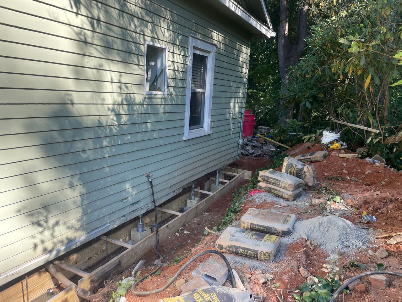 HydroHelp911 Crawl Space & Foundation Repair installing crawl space support jacks and wood framing.