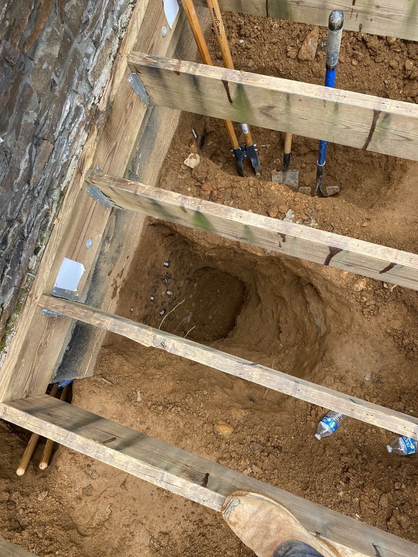 HydroHelp911 Crawl Space & Foundation Repair performing excavation for foundation underpinning installation