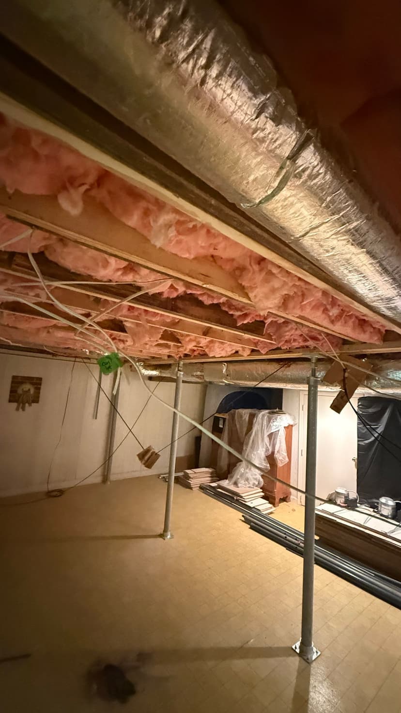 HydroHelp911 Crawl Space & Foundation Repair installing adjustable steel jacks, with exposed joists