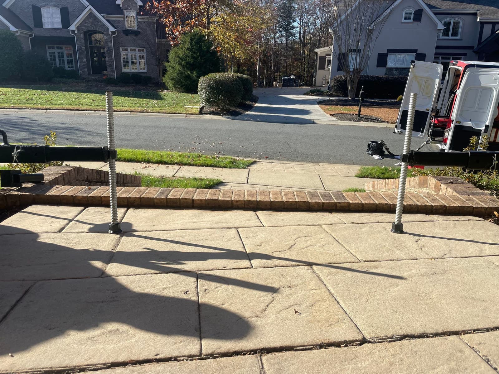 HydroHelp911 Crawl Space & Foundation Repair service vehicle at a residential exterior, lifting a concrete patio.