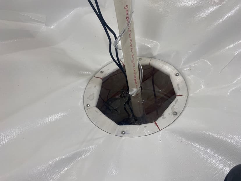 HydroHelp911 Crawl Space & Foundation Repair installing a sump pump with a sealed sump basin lid in a crawl space.