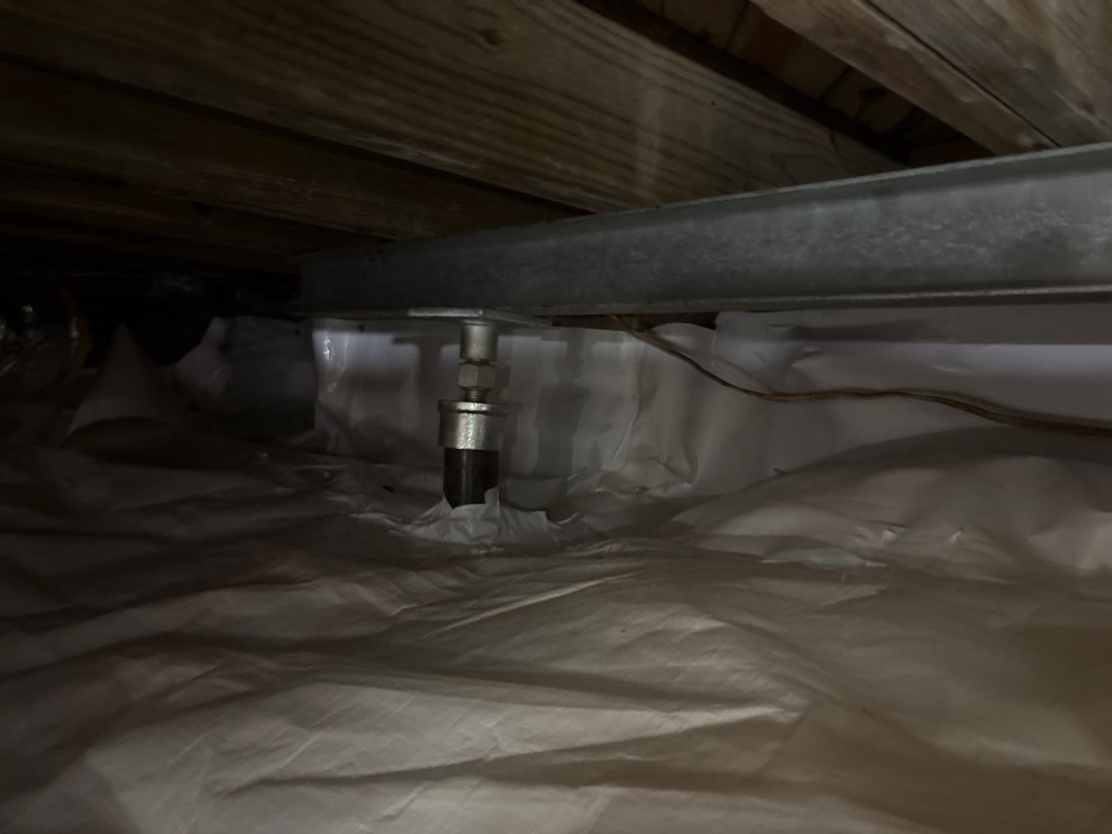 HydroHelp911 Crawl Space & Foundation Repair installing adjustable steel jacks and support beams in a crawl space.