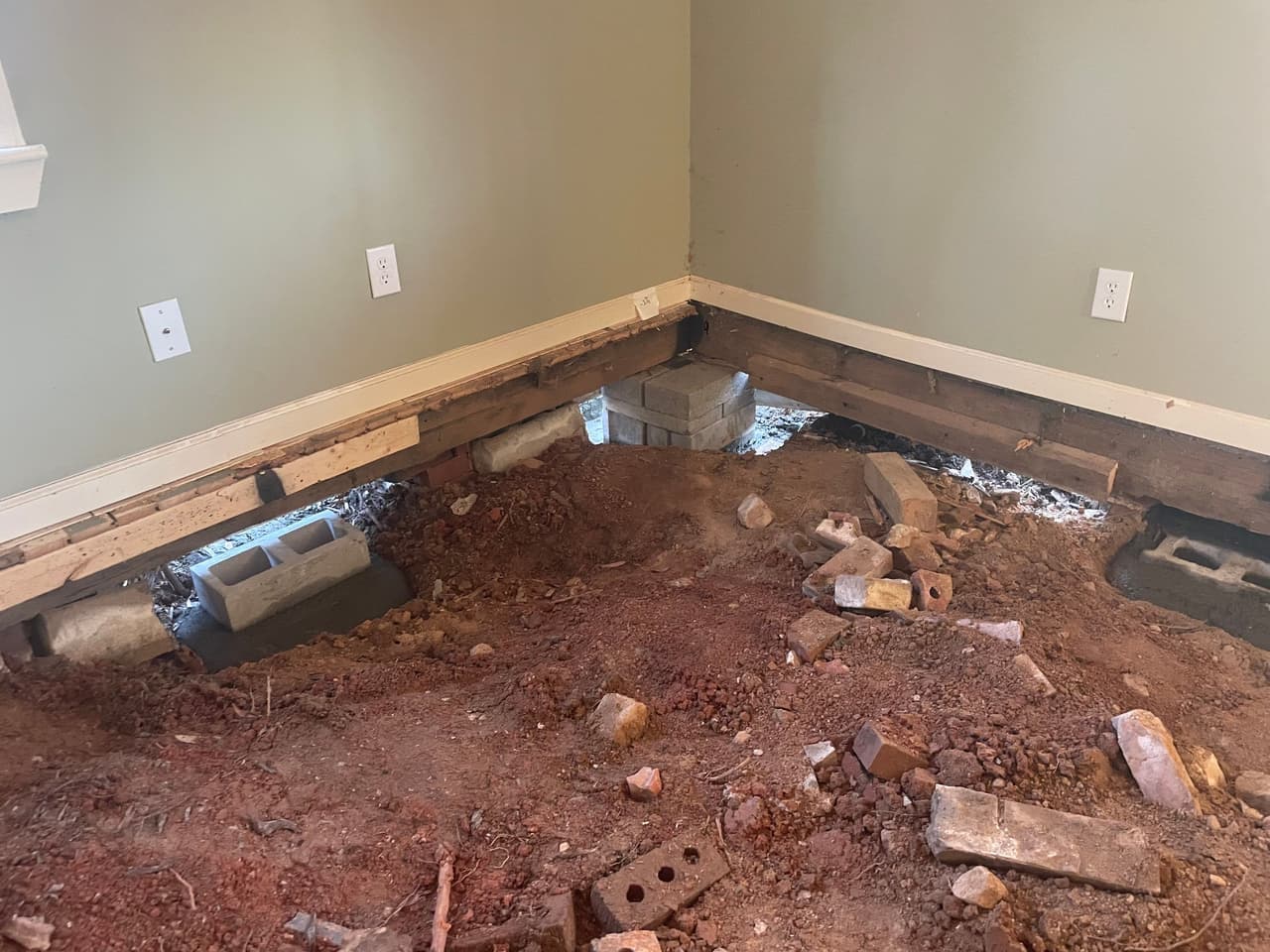 HydroHelp911 Crawl Space & Foundation Repair stabilizing exposed crawl space floor joists with concrete block piers.