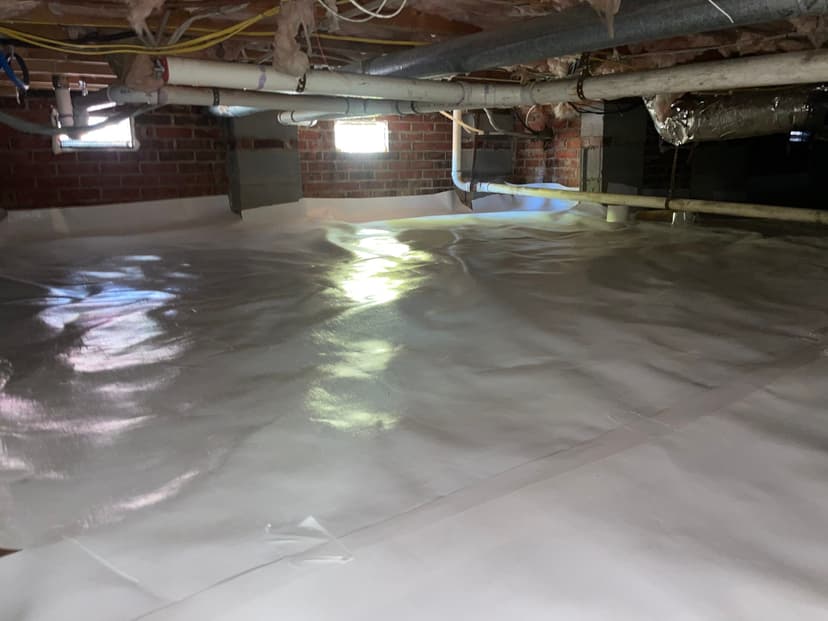 HydroHelp911 Crawl Space & Foundation Repair completing a crawl space encapsulation with a vapor barrier installation.