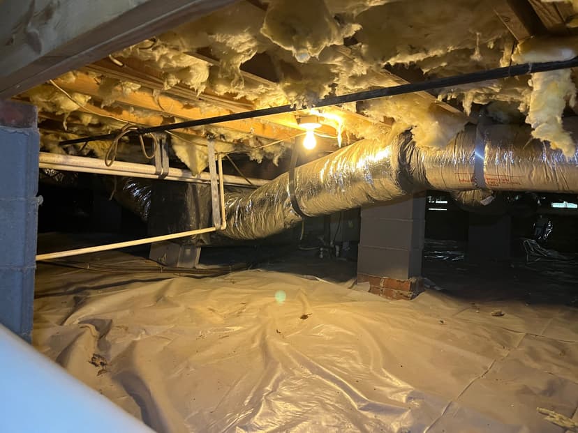 HydroHelp911 Crawl Space & Foundation Repair installing a vapor barrier in a crawl space with deteriorating insulation.