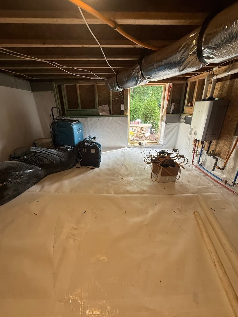 HydroHelp911 Crawl Space & Foundation Repair installing a white vapor barrier and dehumidifier in a crawl space.