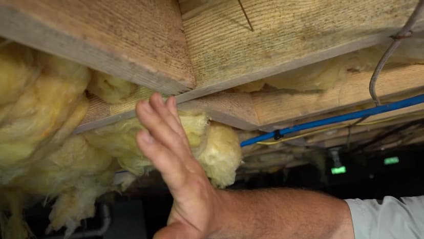HydroHelp911 Crawl Space & Foundation Repair technician inspecting deteriorating crawl space insulation and moisture damage.