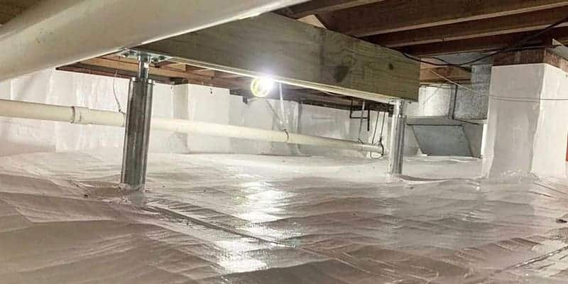 Steel jack posts supporting a beam in an encapsulated crawl space
