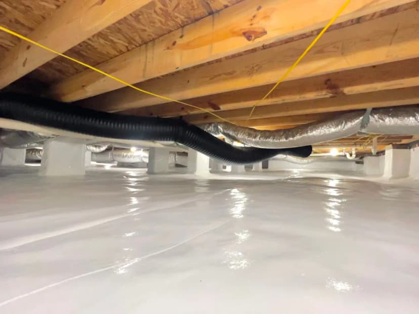 Clean encapsulated crawl space with a white liner and insulated ducts